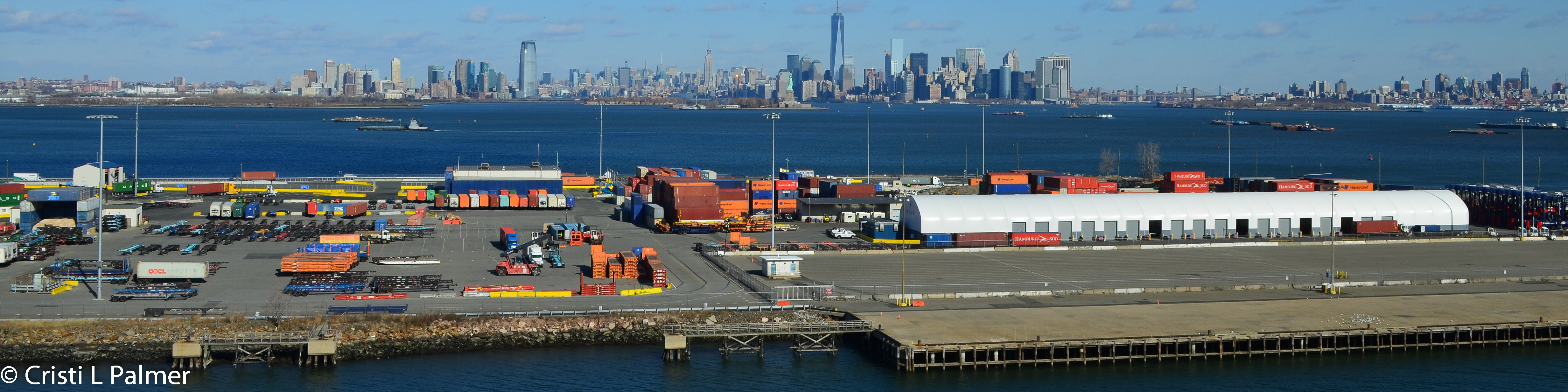 Shipping containers on dock in Bayonne, NJ, New York City skyline is in the background